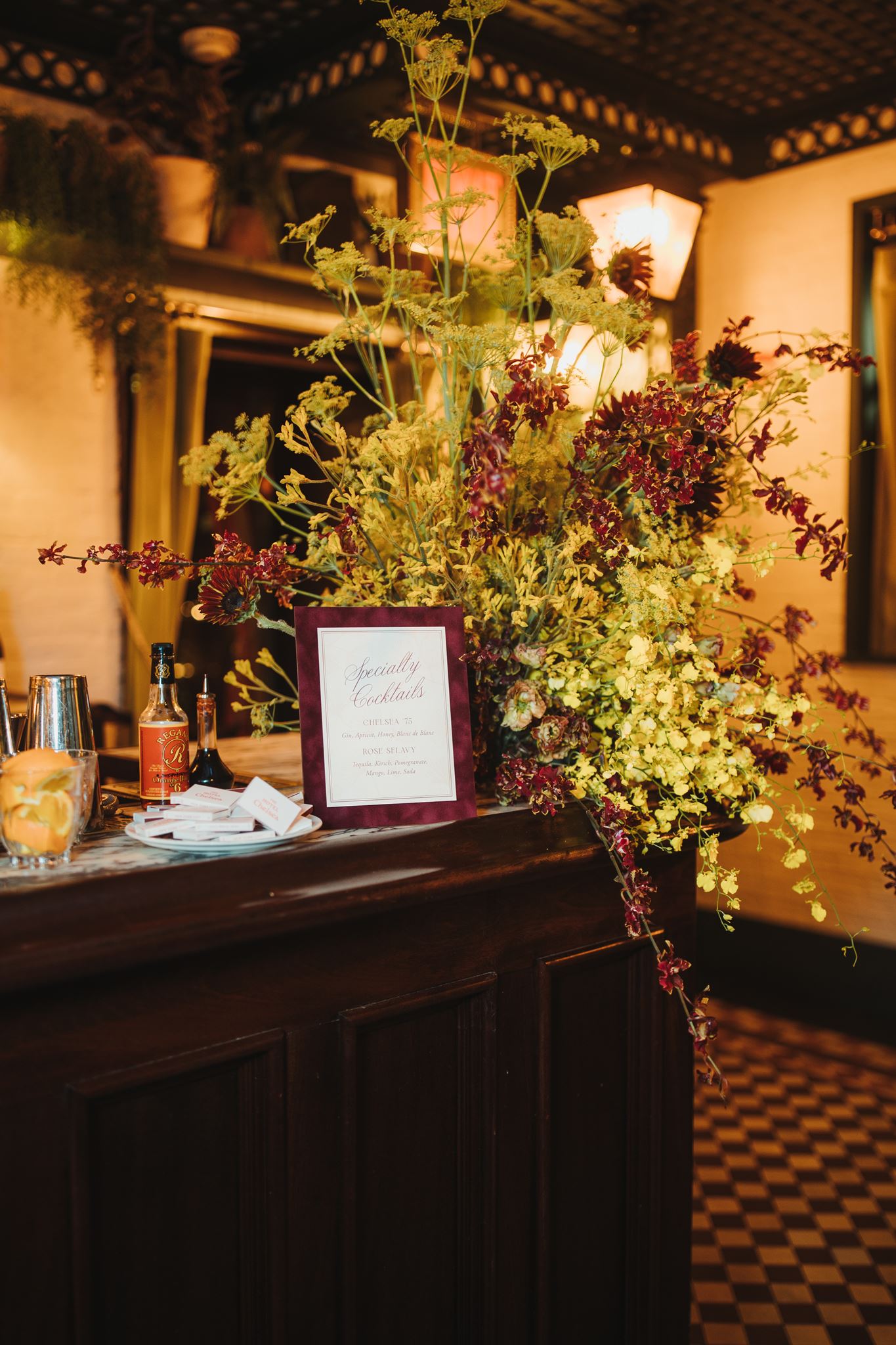Floral Arrangement and Custom Sign on Bar at Manhattan Wedding