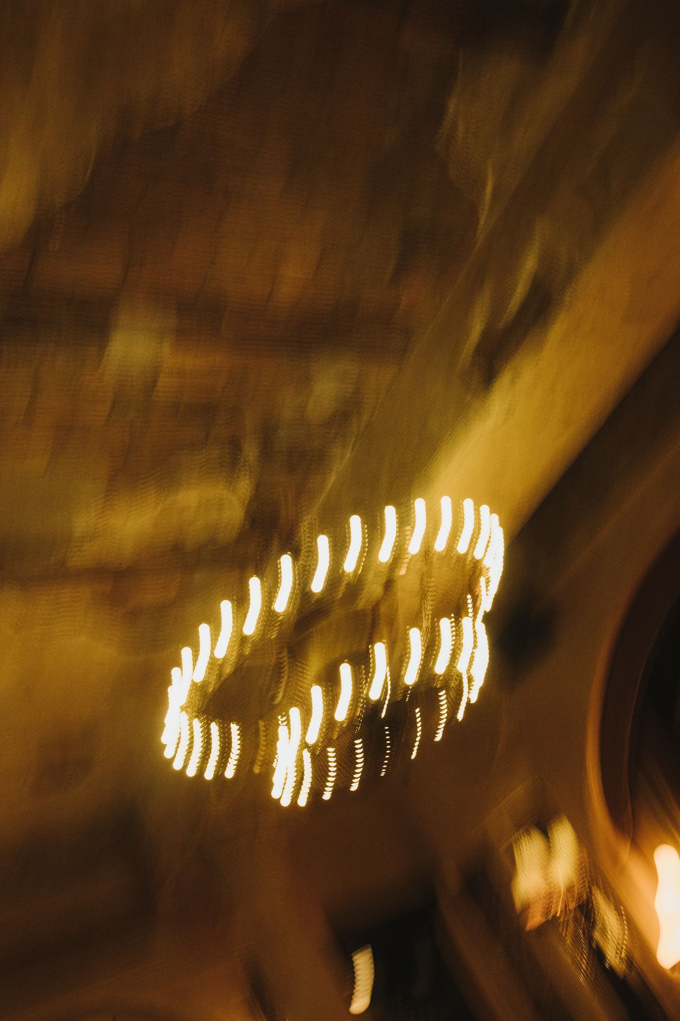 Blurry Photo of Softly Lit Chandelier Hanging in Bard Room at Hotel Chelsea