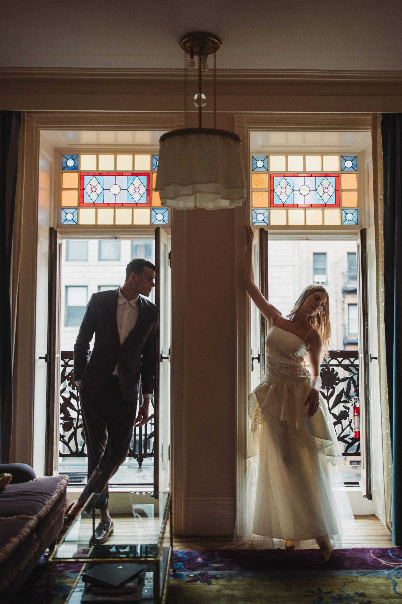 Bride and Groom Pose Side by Side in Doorway of Balcony at NYC Hotel Chelsea