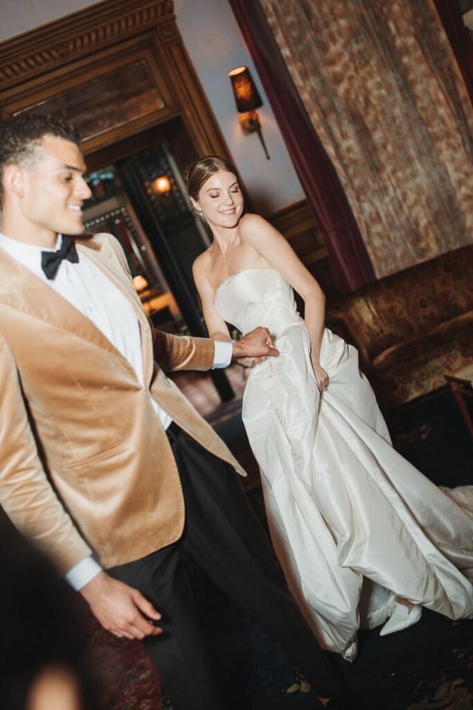 Bride and Groom Walk Hand in Hand to Wedding Reception at Manhattan Hotel