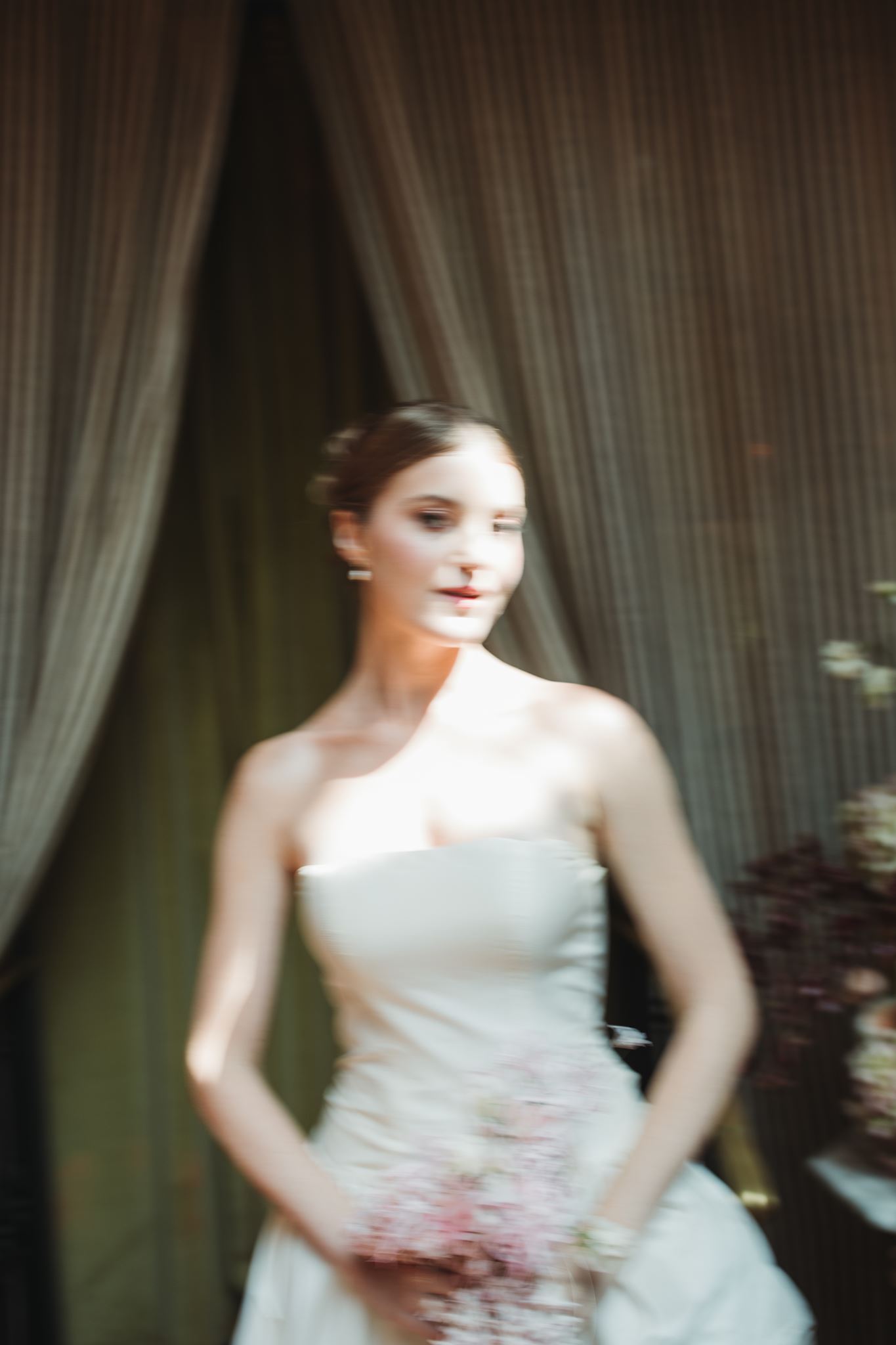 Blurred Photo of Elegant Bride Walking Down Aisle at Wedding