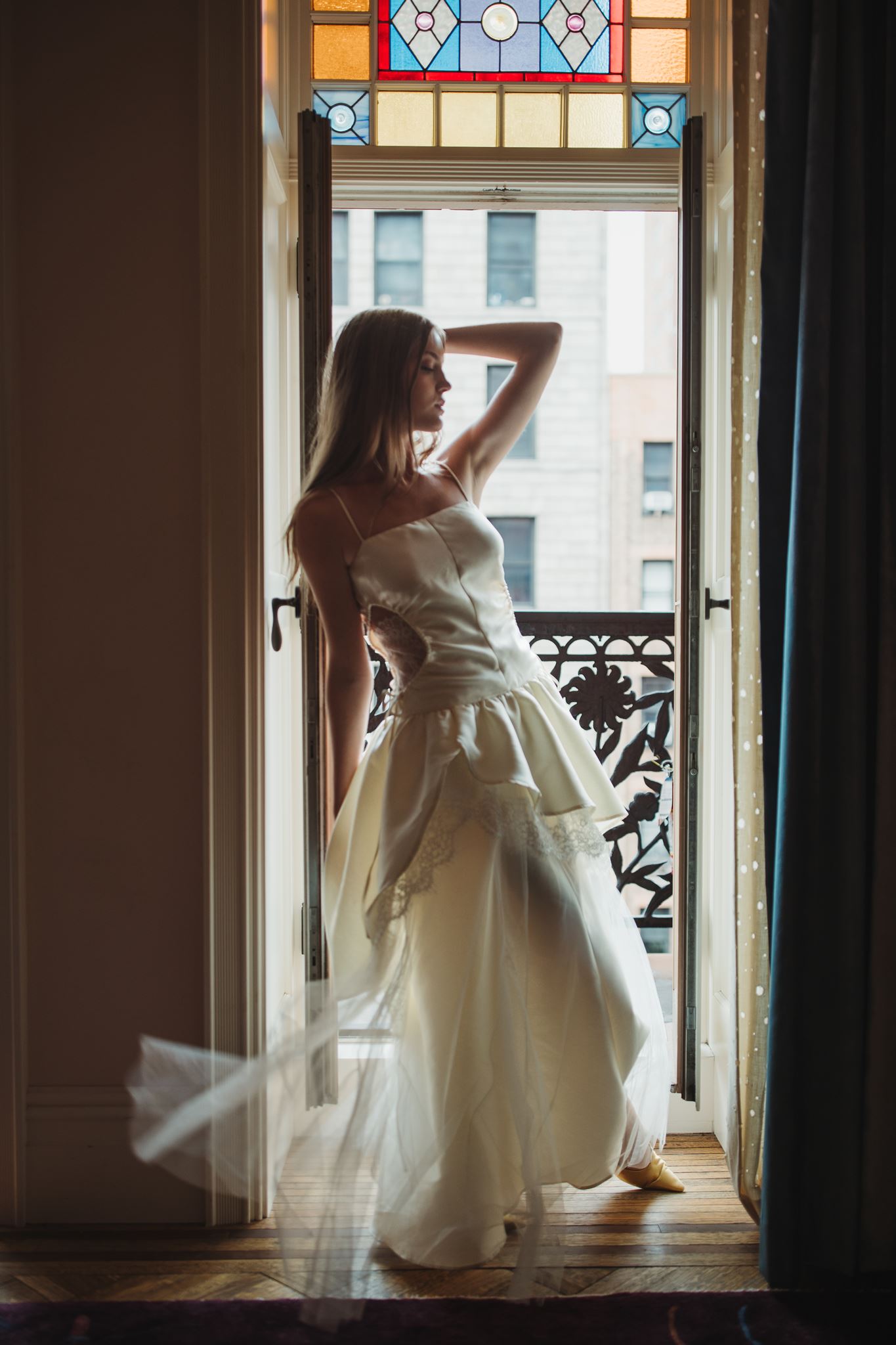 Bride Standing in Front of Doorway in Balcony at Hotel Chelsea in Manhattan