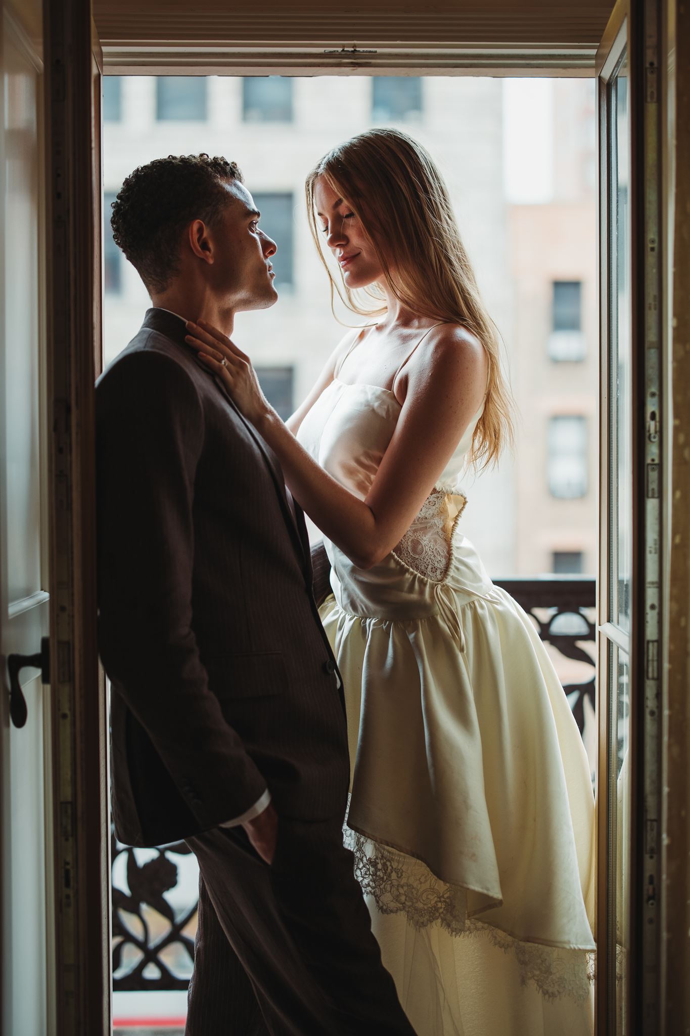 Bride and Groom Lean in for Kiss on Balcony of Hotel Chelsea